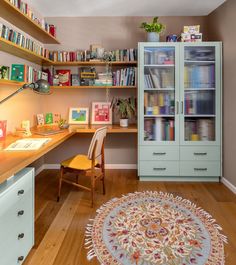 a home office with bookshelves, desk and chair in the middle of it