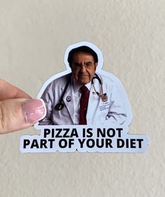 a person holding up a sticker that says pizza is not part of your diet