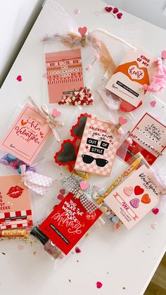 many valentine's day cards are laid out on a table with confetti