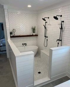 a bathroom with white tile and black fixtures on the shower head, tub, and sink