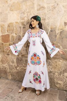 Discover the epitome of bohemian elegance with our Cotton Embroidered Maxi Dress, a masterpiece meticulously crafted by skilled artisans in Mexico. This exquisite dress features intricate hand-embroidery, showcasing the rich cultural heritage of Mexican craftsmanship.  With its flowing silhouette and soft, breathable cotton fabric, it's the perfect blend of comfort and style for any occasion, transporting you to a world of timeless beauty. It has ties in the back for an adjustable fit.  This dre Latina Fashion Dresses, Dress Latina, Mexican Style Dresses, Mexican Embroidered Dress, Mexican Outfit, Latina Fashion, Beauty Hair Makeup, Mexican Dresses, Floral Embroidered Dress