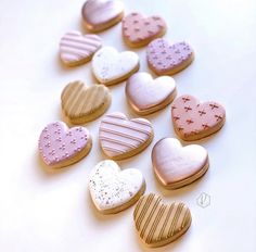 heart shaped cookies are arranged on a white surface