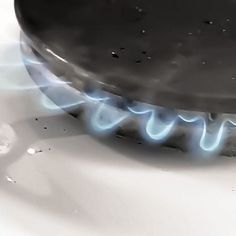 a gas burner with blue flames coming out of it's top and bottom