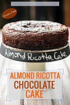 an almond ricotta chocolate cake on a wooden table with the words almond ricotta cake above it