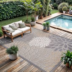 an outdoor area with a pool and wooden decking, potted plants and furniture