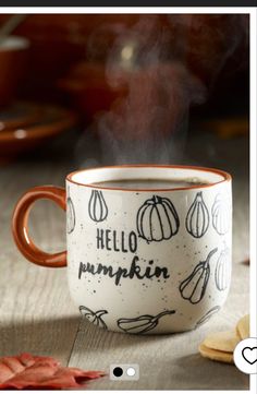 a coffee cup with the words hello pumpkin printed on it and some hot chocolate chips