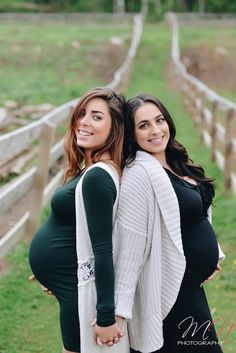 two pregnant women standing next to each other