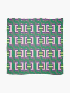 a green, purple and yellow blanket with geometric design on the bottom half of it