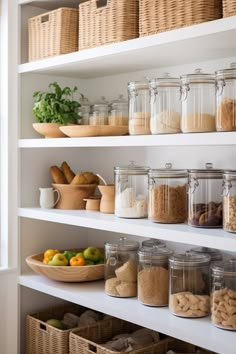 an organized pantry filled with lots of food and snacks in glass jars on white shelving