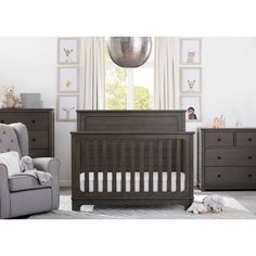 a baby's room with furniture and pictures on the wall, including a crib