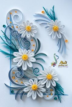 paper art with flowers and swirls on the bottom, in blue and white colors