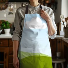 a woman wearing an apron with a cloud painted on it