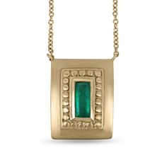 Displayed in a one of a kind, green-gold, Colombian emerald hand-made necklace. A divine 1.60-carat elongated emerald sits in a secure bezel setting. The alluring centerpiece displays a rich blue-green color, true to its prized origin; Muzo, Colombia. Beautiful clarity is seen in this gem as it is eye-clean, and small imperfections are natural, adding ambiance and character to the stone. A golden halo rises around the gemstone, providing texture and depth. A hand-brushed satin finish is dexterously applied to the unique green-gold piece. Setting Style: Bezel Setting Material: 18K Green & Yellow Gold Chain Length: 18 inches Main Stone: Colombian Emerald Shape: Elongated Emerald Cut Weight: 1.60-carat Total Stones: One Clarity: Very Good Color: Bluish Green Luster: Excellent Origin: Colombia Emerald Statement Necklace, Green Emerald Necklace, Necklace Emerald, 14k Yellow Gold Necklace, Solitaire Necklace, Solitaire Pendant Necklace, Gold Anniversary, Drop Pendant Necklace, Colombian Emeralds