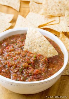 a white bowl filled with salsa and tortilla chips