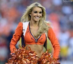 a woman in an orange and white cheerleader outfit