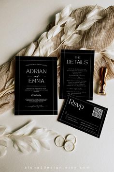 two black and white wedding cards with feathers