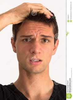 a young man holding his hair in front of his head and looking at the camera