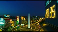 the city is lit up at night and it looks like there are many billboards