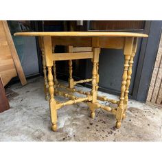 a wooden table sitting on top of a cement floor