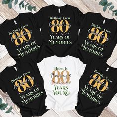 six birthday shirts with the number 80 and years of memories printed on them, sitting next to each other