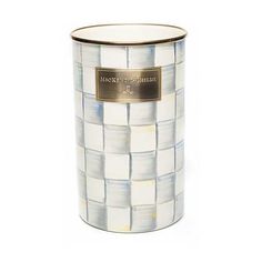 a white and gold canister with a label on it