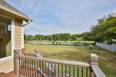 the back porch has a view of an open field