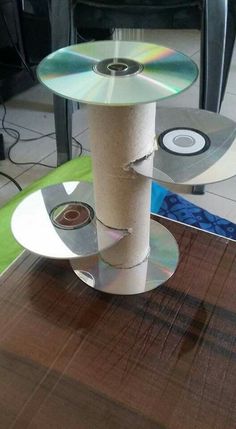 three cds are stacked on top of each other in the middle of a table,