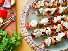 several skewers filled with meat and vegetables on a plate