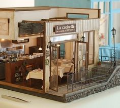 a miniature model of a restaurant with tables and chairs