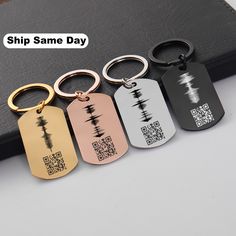 four different styles of dog tags with qr code printed on the front and back