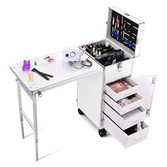 a white desk with drawers and an open drawer on the top that has makeup products in it