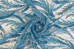 blue and silver sequins on white fabric