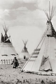 an old black and white photo of native american teepees