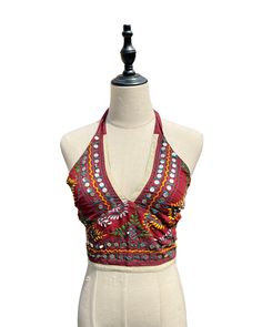 This vibrant, hand-embroidered bikini halter top offers stylish Boho-inspired fashion with its colorful threads and sequin embellishments. Paired with jeans or a skirt, this is the perfect summer top to stand out in and make a statement. The lining is a contrasting color to give it a unique, eye-catching look. One Size Made in India Care Instructions: Dry clean only Hawaii Fits, Girl In The Mirror, Boho Halter Top, Colorful Threads, 70s Inspired Fashion, Beach Fits, Senior Trip, Fashion Board, 70s Inspired