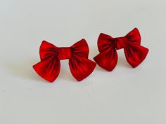 These red bow stud earrings have a velvety,satiny look to them. They are made of resin and have sterling silver posts. They measure approximately 1/2 an inches Your earrings will arrive packaged and ready for gifting. Red Christmas Earrings For Formal Occasions, Red Earrings For Christmas Formal Events, Red Earrings For Christmas Formal Occasion, Valentine's Day Party Jewelry With Red Bow, Bow Earrings For Valentine's Day Gift, Elegant Jewelry With Red Bow For Gifting, Red Christmas Jewelry, Elegant Red Jewelry With Bow, Christmas Pic