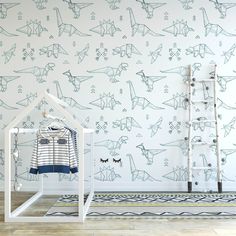 a room with dinosaur wallpaper and clothes rack