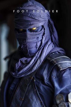 a man wearing a purple mask and leather jacket with his eyes covered in yellow light