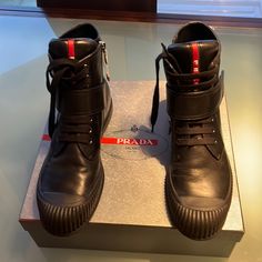 Woman’s Prada Shoes Combat Sneaker, Black Size 40-10 Black Low-top Calf Leather Boots, Designer Black Low-top Boots, Designer Leather Low-top Boots, Luxury Black Sneakers With Removable Insole, Black Sneakers With Red Sole In Calf Leather, Black Calf Leather Sneakers With Red Sole, Designer Black Boots With Medium Fit, Designer Black Boots Medium Fit, Prada Monolith Boots