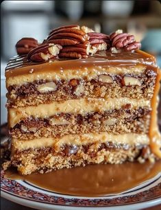 a piece of cake on a plate with pecans and caramel drizzle