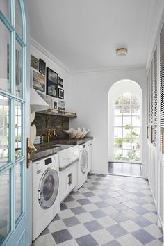 a laundry room with washer and dryer in it next to an arched doorway