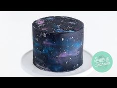 a space themed cake on a plate with the words sugar & sparrow written in it