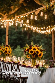 the table is set with sunflowers and candles for an outdoor wedding reception at dusk