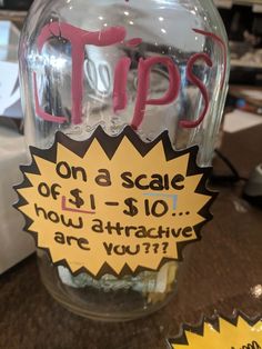 a glass jar with writing on it that says tips on a scale off $ 10 how attractive are you?