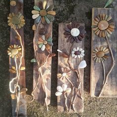 three wooden boards with flowers and leaves on them, one is made out of wood