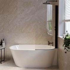 a white bath tub sitting next to a window