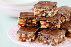 chocolate bars stacked on top of each other in front of a white bowl and plate