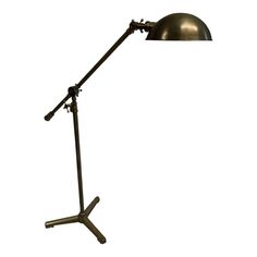 a metal desk lamp with a black shade on the top and one light on the bottom