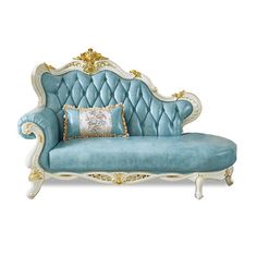 a blue couch with gold trimmings and pillows on top of it's back