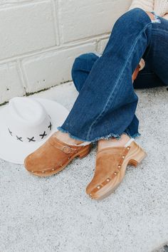 Stay on trend with our Chinese Laundry Carlie Brown Clogs! The leather clogs feature a buckle detail, a woodgrain platform heel, and have silver studded accents. These look best paired with a sweater, wide leg jeans, and a cute wide brim hat. Complete your outfit with these adorable clogs! Upper: Leather. Lining: Faux Shearling. Synthetic Sole. Heel: 2.5" Platform: 1" Brown Clogs, Brown Flats, Leather Clogs, Chinese Laundry, Platform Heel, Hello Gorgeous, Wide Brimmed Hats, Brim Hat, Fall Looks