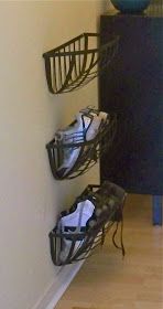 there is a pair of shoes on the floor in front of a wall with baskets